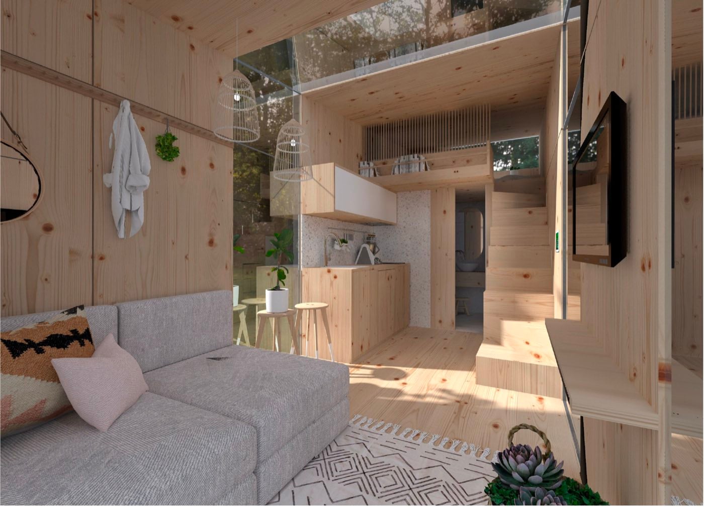 Intérieur tout bois : canapé d'angle, cuisine compacte et escalier vers la mezzanine